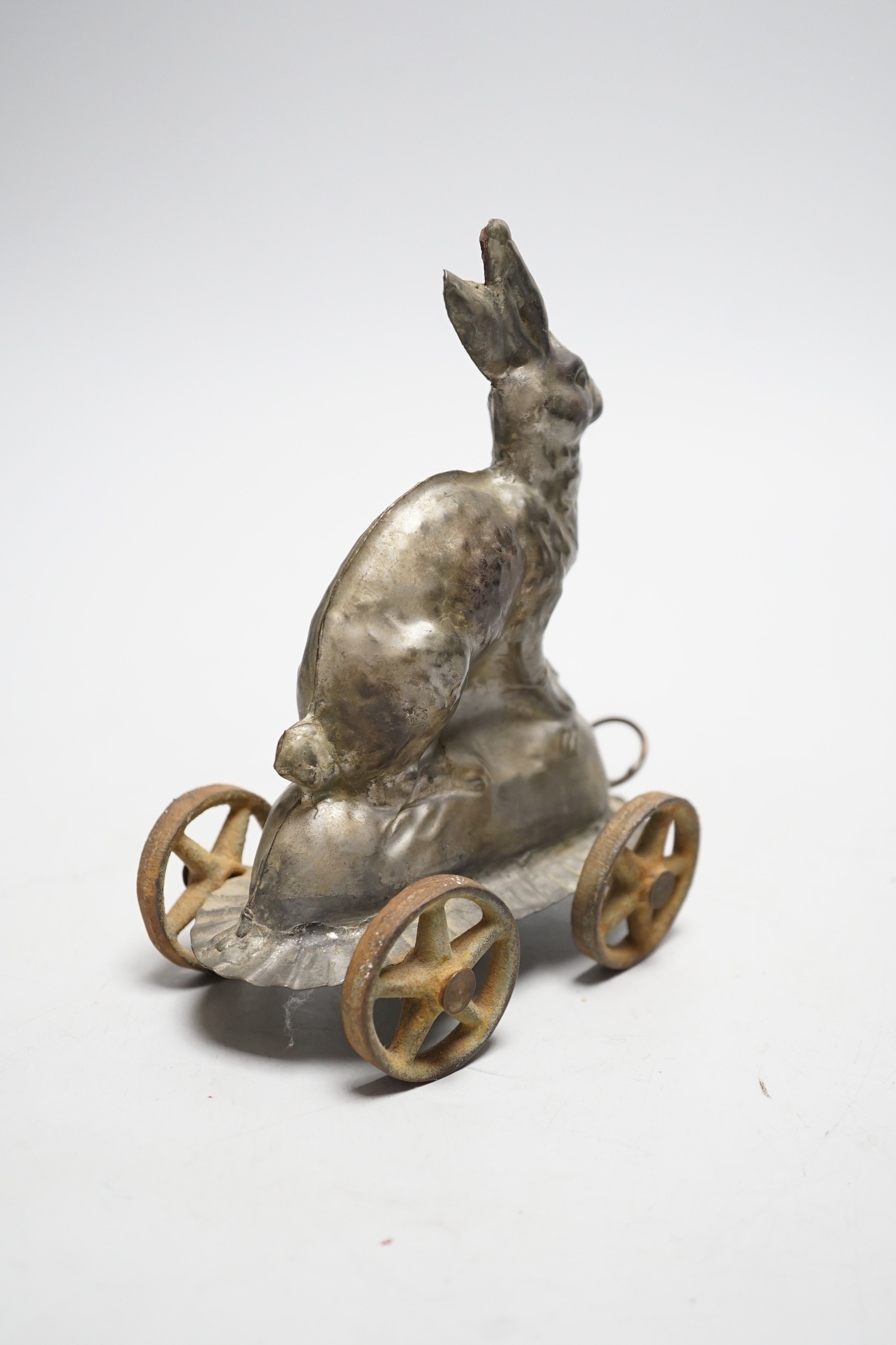 A late Victorian / Edwardian confectioners’ rabbit shaped mould, on four wheels, 15cm tall